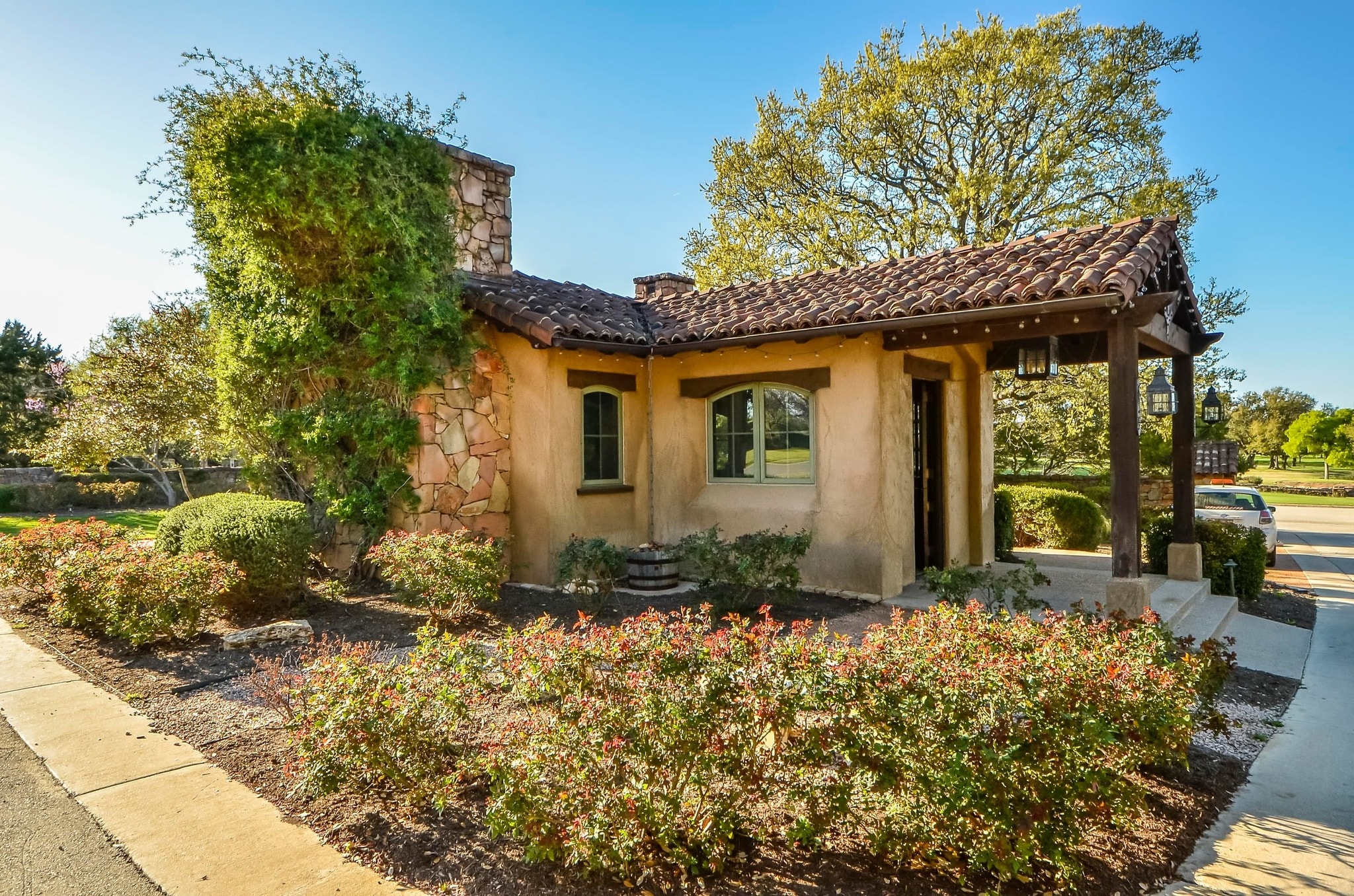 Club main entrance building with Spanish tile roof and landscaping