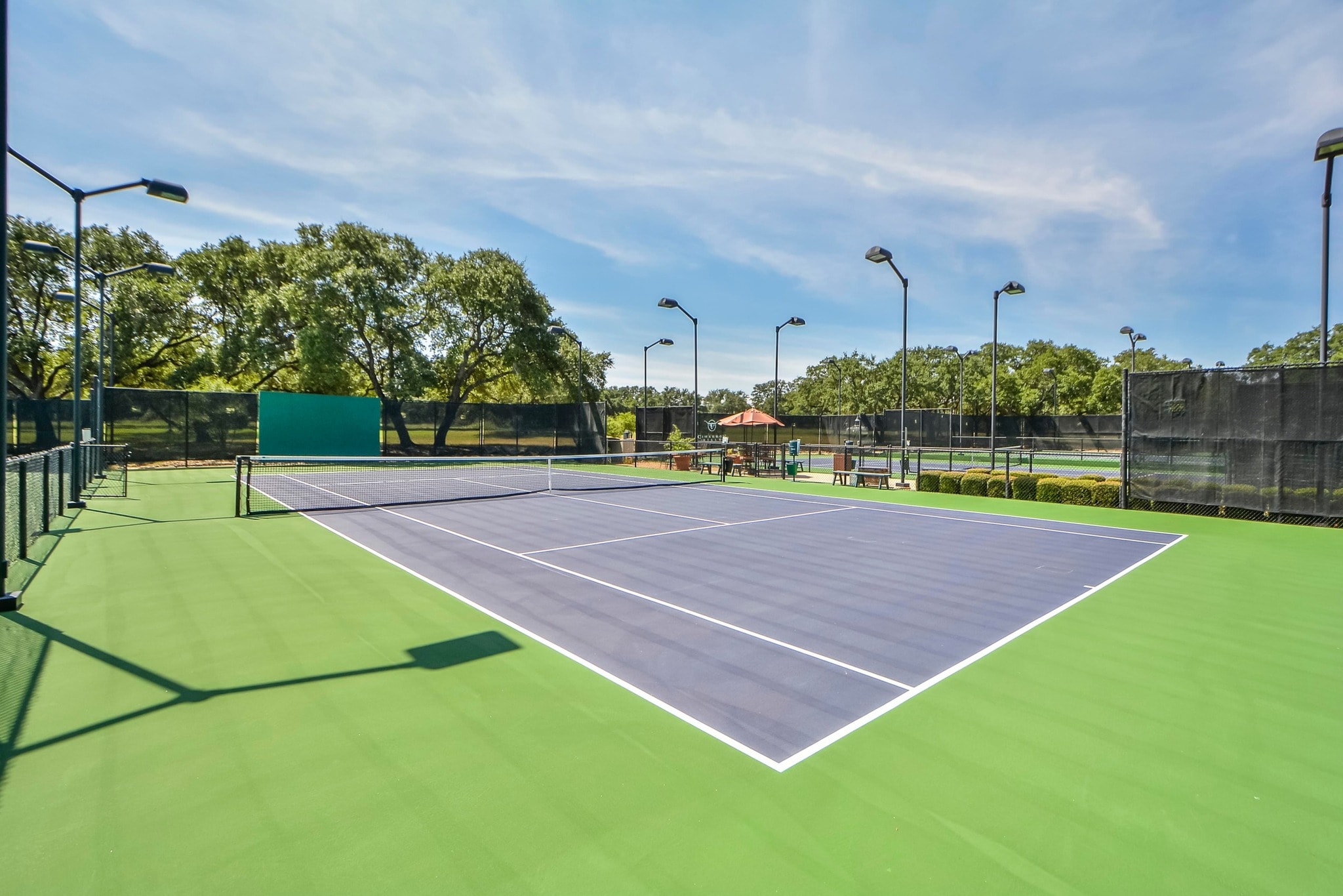 Cimarron Hills tennis courts with green and blue hard court surfaces and lights