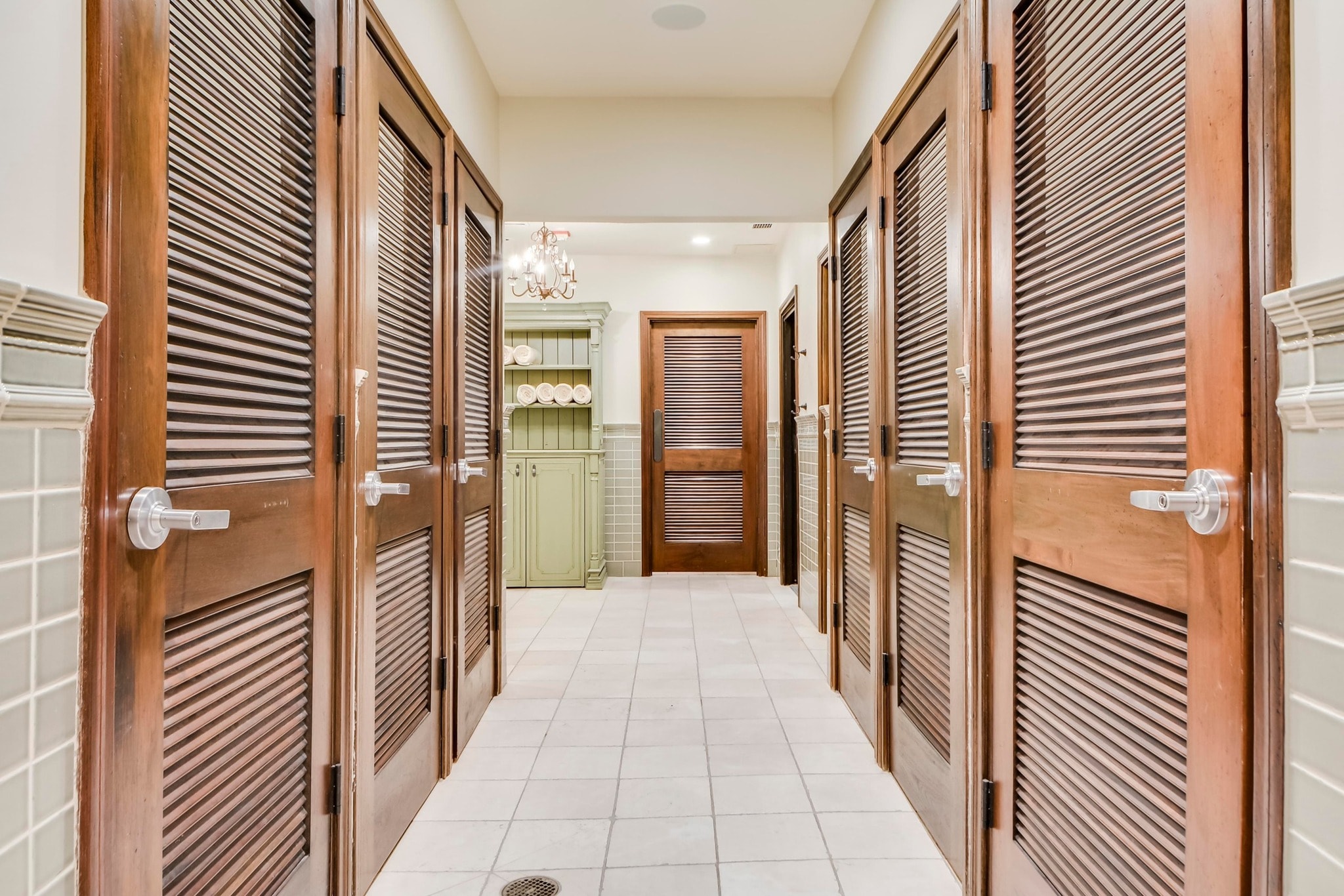 Club locker room hallway with wood louvered doors
