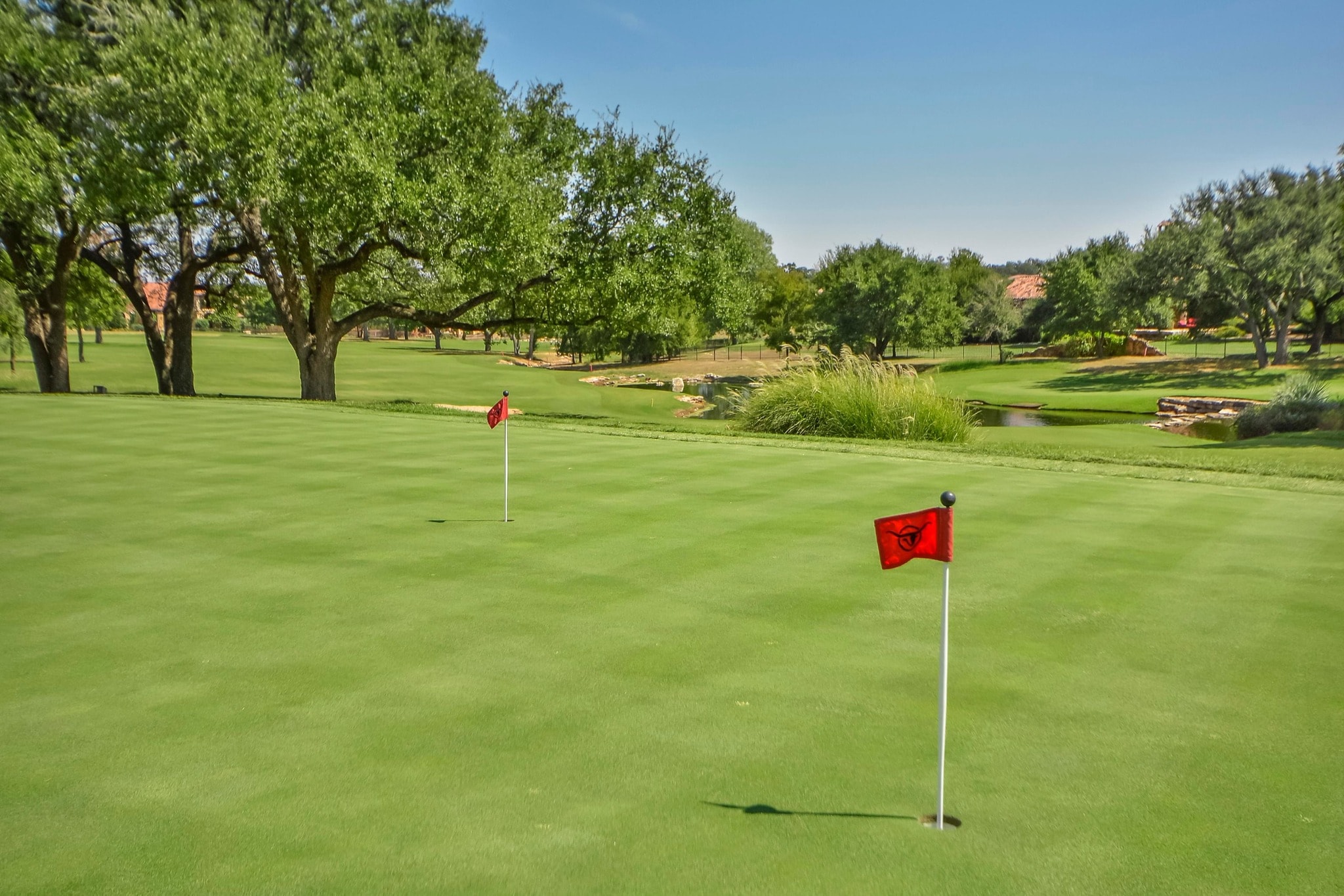 Championship golf course green with red Cimarron Hills flags
