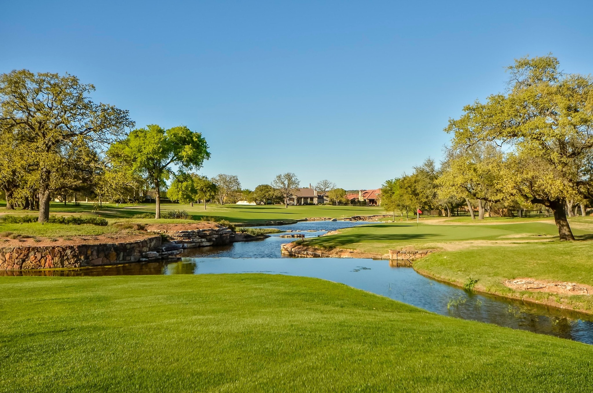Golf course with stone-lined creek and water feature